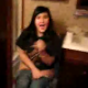 Some guy sneaks into the bathroom to scare his girlfriend, who is sitting on the toilet. She is most likely shitting. No poop sounds.